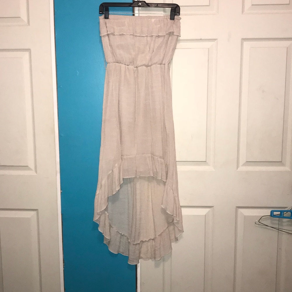 Cream colored long strapless dress.
